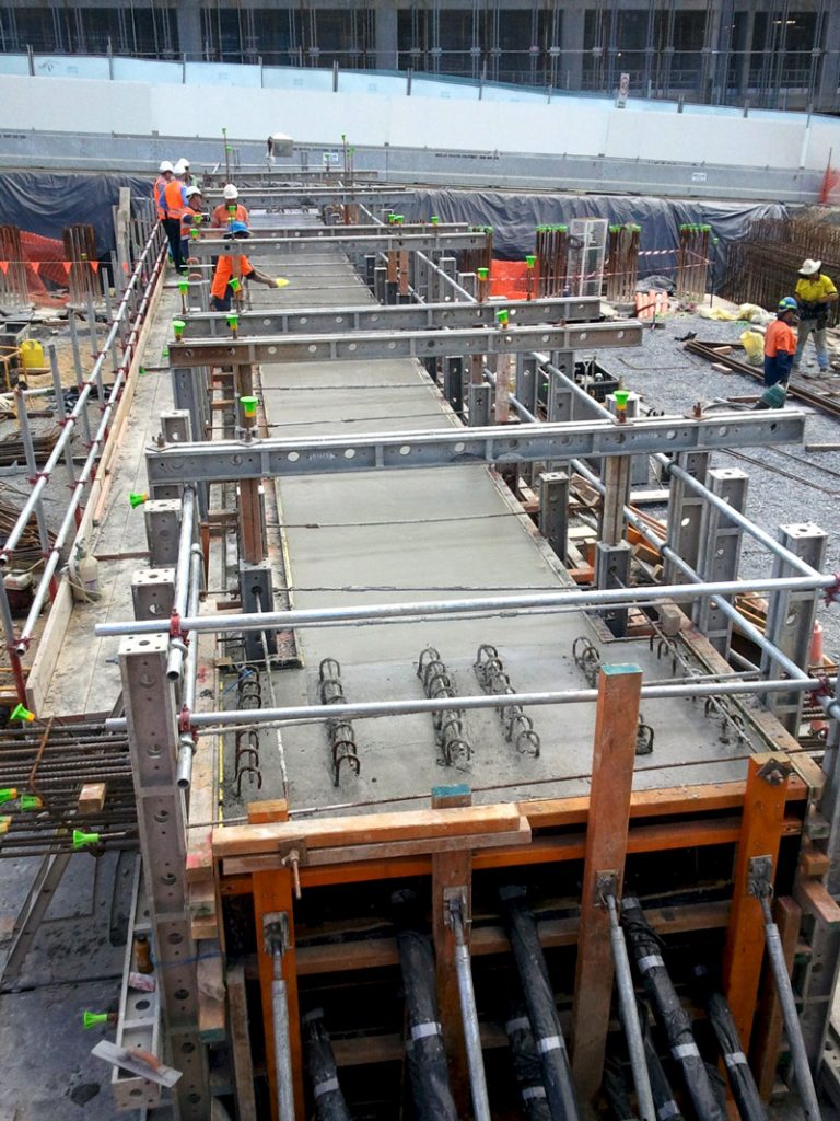 construction of various structures throughout the project including capping beams, retaining walls, post tensioned beams, reinforced concrete beams, deck slabs and pavement works.